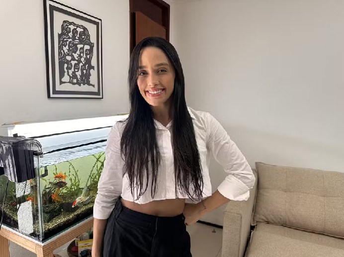 foto de eva ao lado do aquário em sua casa